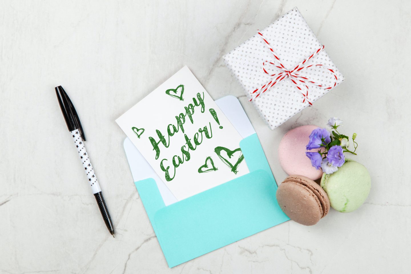 pexels-giftpunditscom-2072179 Easter recipe ideas: an overhead photo of a Happy Easter card on a table with macarons and a present box
